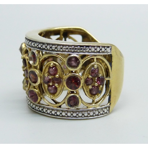 932 - An ornate silver gilt and garnet ring, R