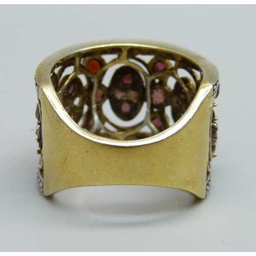 932 - An ornate silver gilt and garnet ring, R