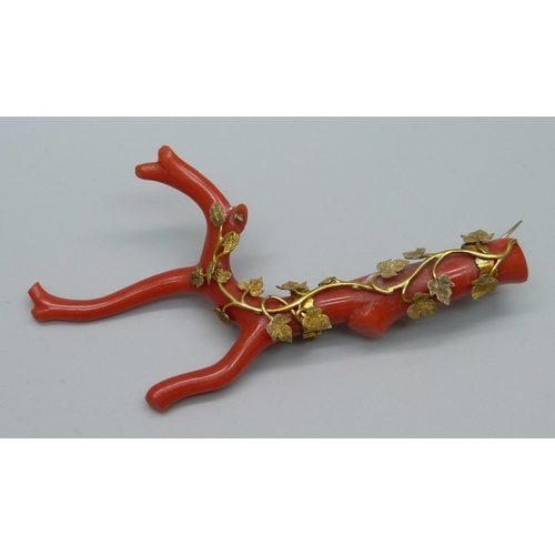 936 - An antique yellow metal mounted stick coral brooch, tests as 15ct gold, 9.5cm, lacking one leaf