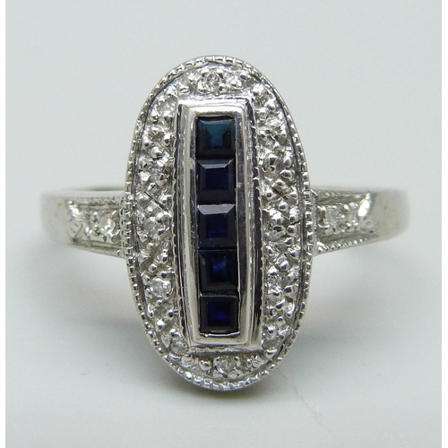 944 - A 9ct white gold, blue stone and diamond Art Deco style ring, 3.5g, R