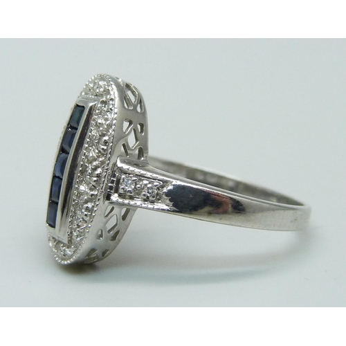 944 - A 9ct white gold, blue stone and diamond Art Deco style ring, 3.5g, R