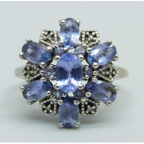 953 - A 9ct white gold cluster ring, set with tanzanite and small diamonds, 2.9g, O