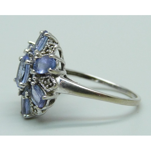 953 - A 9ct white gold cluster ring, set with tanzanite and small diamonds, 2.9g, O