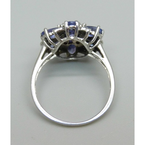 953 - A 9ct white gold cluster ring, set with tanzanite and small diamonds, 2.9g, O