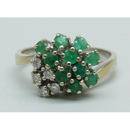 959 - An 18ct gold, emerald and diamond cluster ring, 4.9g, O