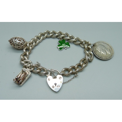 970 - A fancy link silver charm bracelet, 49g