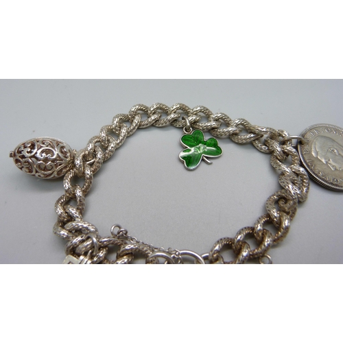 970 - A fancy link silver charm bracelet, 49g