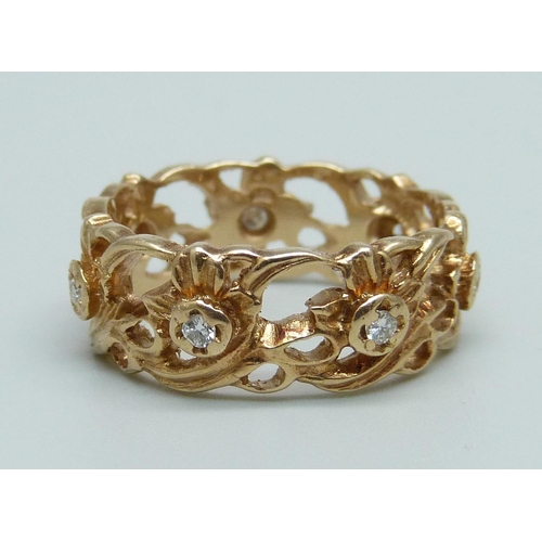 974 - A 14ct gold ring with seven diamonds, 6.5g, S