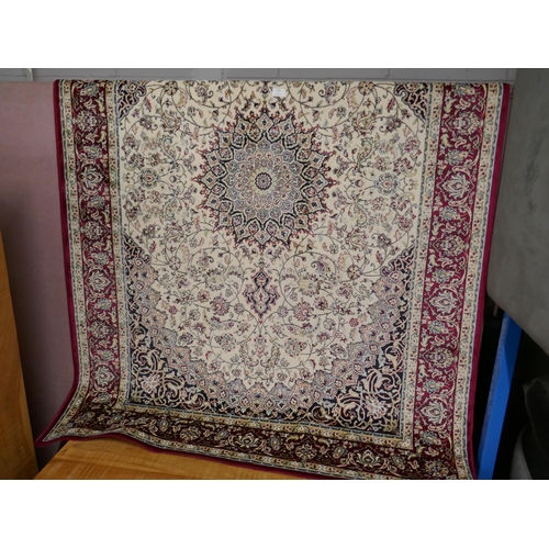 1399 - A red and ivory ground Keshan rug, 190 x 140cm