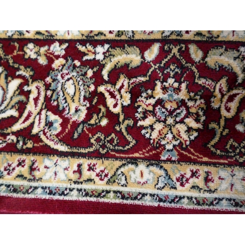 1399 - A red and ivory ground Keshan rug, 190 x 140cm