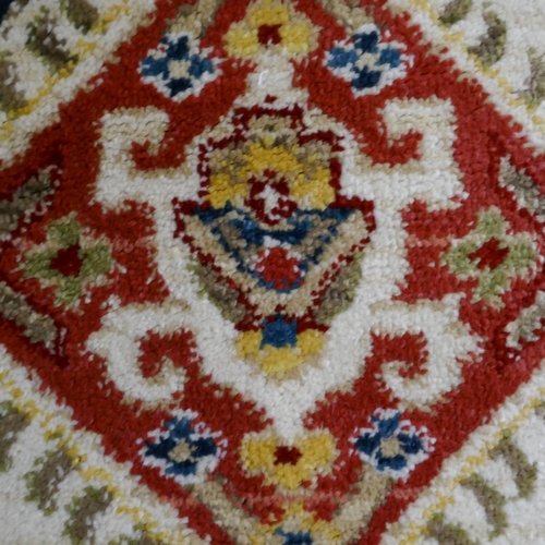 1445 - A cream ground all over diamond design rug, 170 x 120cm