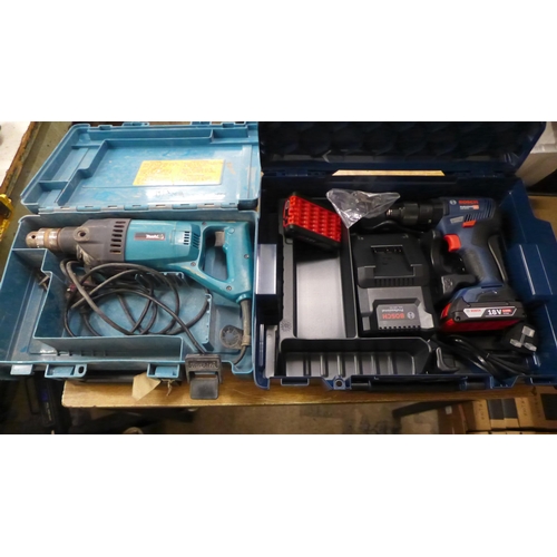 2062 - 2 Boxed power tools; a Makita 240v hammer drill (8406) and a Bosch professional heavy duty 18v cordl... 