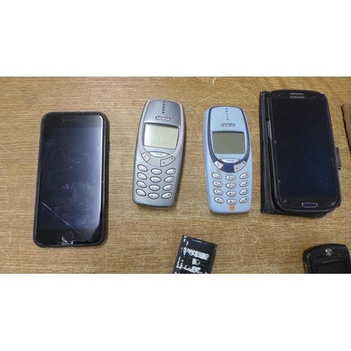 2119 - A collection of phones including an iPhone, Samsung, two Blackberry Curves, Nokia, etc.