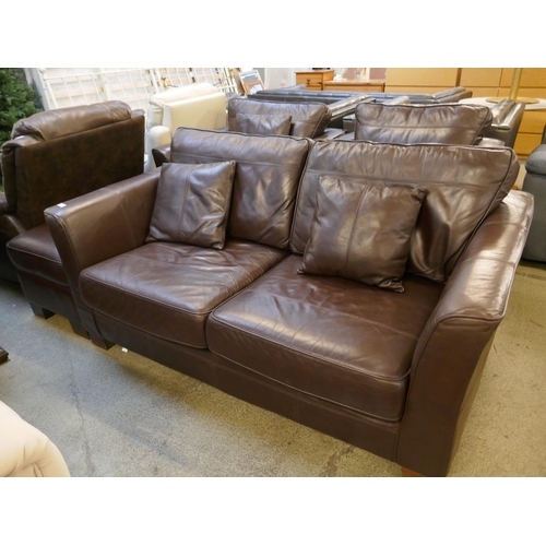 1561 - A brown leather three seater sofa, two arm chairs and footstool