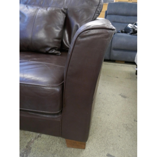 1561 - A brown leather three seater sofa, two arm chairs and footstool