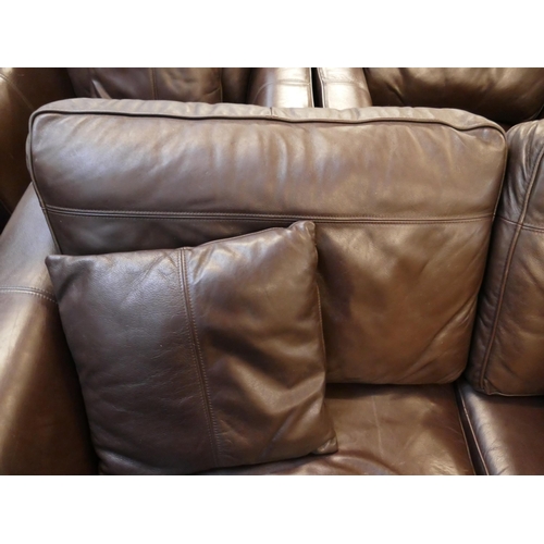 1561 - A brown leather three seater sofa, two arm chairs and footstool