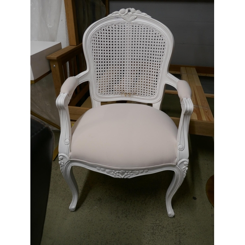 1596 - A white upholstered chair with rattan detail - damaged