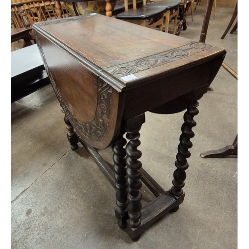 81A - A carved oak barleytwist occasional table