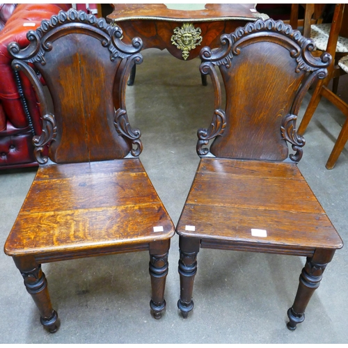 81B - A pair of Victorian oak hall chairs