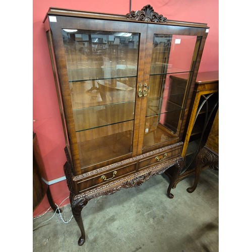 94 - A Queen Anne style carved walnut display cabinet