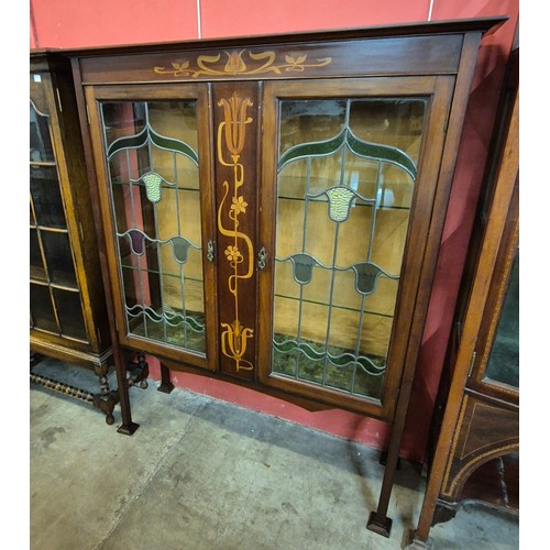 90 - An Art Nouveau inlaid mahogany side cabinet