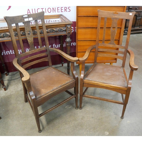 101 - A pair of Arts and Crafts oak elbow chairs