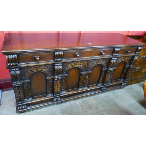 106 - An Elizabethan Revival carved oak dresser