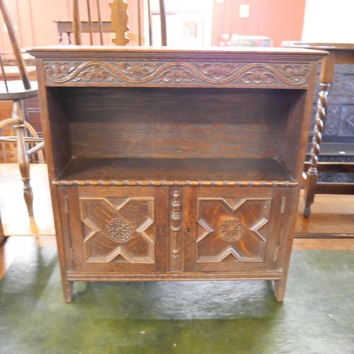 113 - A Jacobean Revival carved oak cupboard