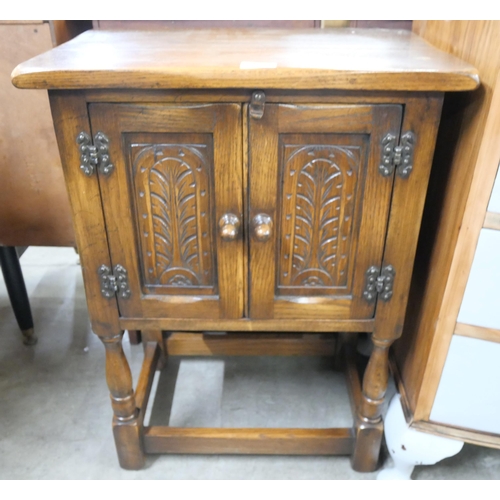 151 - A small carved oak cupboard
