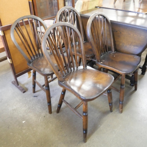 174 - An oak drop-leaf table and four chairs