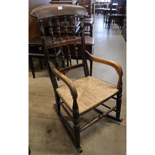 190 - A Victorian elm and rush seated rocking chair