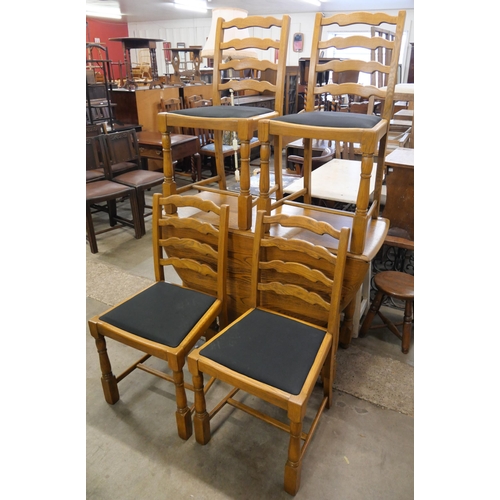 237 - An oak drop leaf table and four chairs