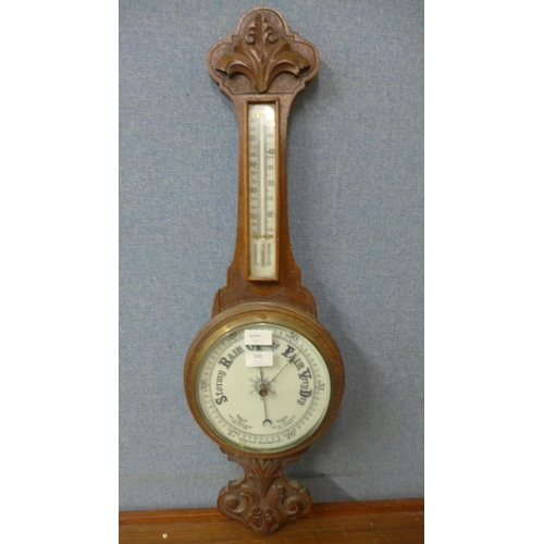 330 - An early 20th Century carved oak aneroid barometer