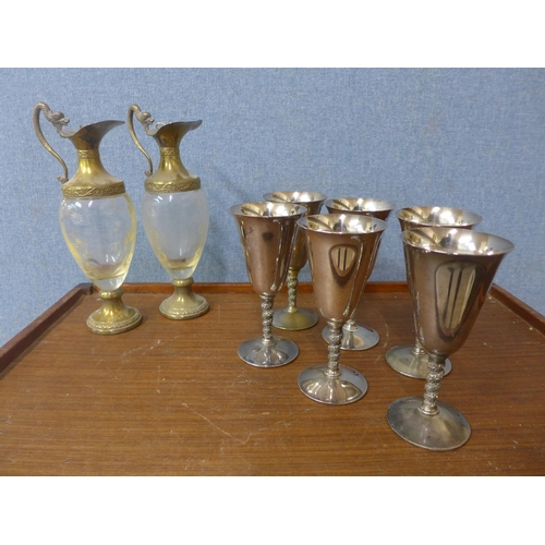 332 - A set of six Falstaff silver plated goblets and a pair of gilt metal and glass ewers