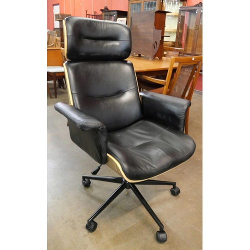 35 - An Eames style simulated rosewood and black leather revolving desk chair