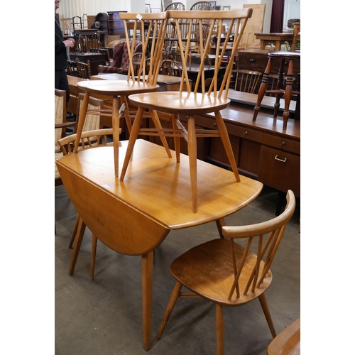 46 - An Ercol Blonde elm and beech Windsor drop leaf table and four candlestick back chairs