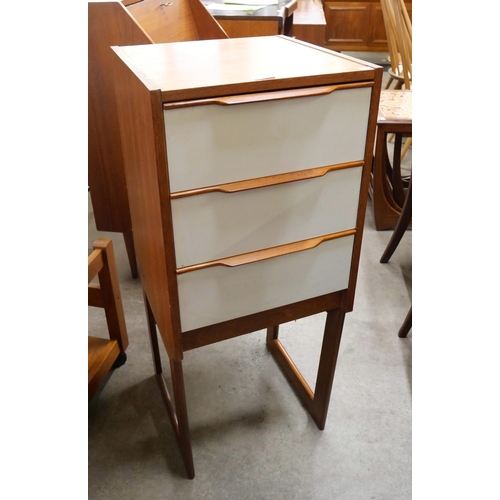 56 - A teak and white laminate chest of drawers