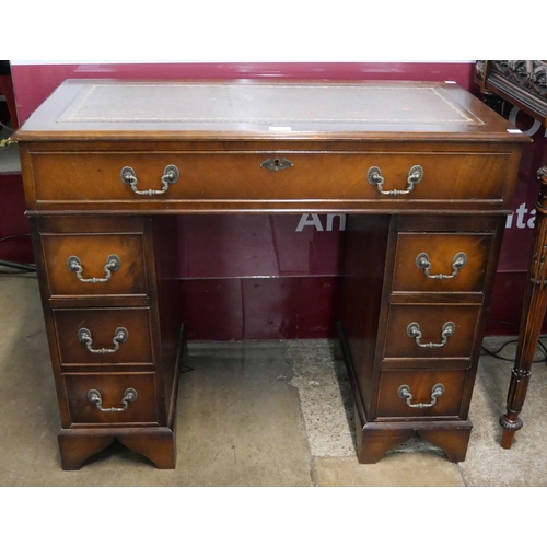 97 - A George II style mahogany and brown leather topped pedestal desk