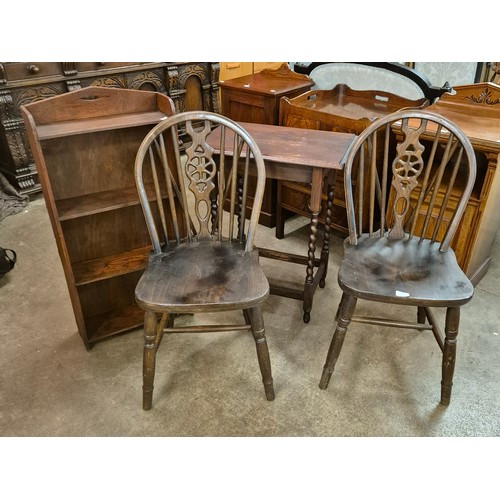 102 - A pair of beech kitchen chairs, an oak bookcase and an oak barleytwist occasional table