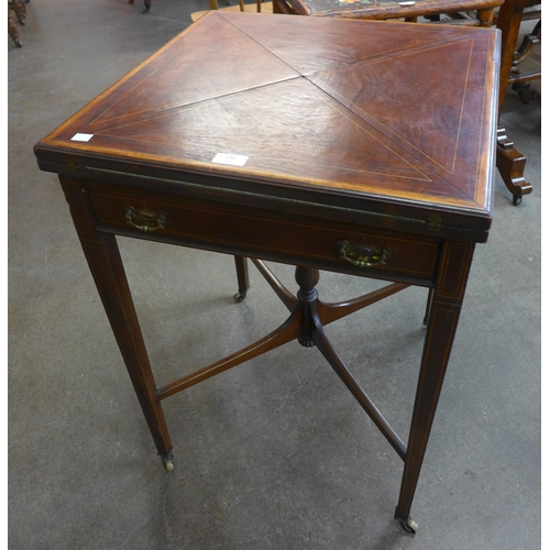 132 - An Edward VII inlaid mahogany envelope games table