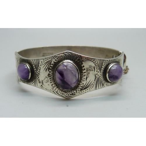 1002 - A hallmarked silver bangle set with cabochon amethyst, Birmingham 1971, Excalibur, 27g