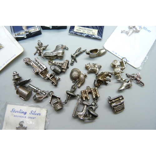 1017 - A collection of silver and white metal charms