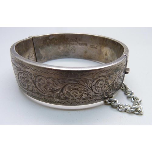 1023 - A Victorian silver bangle, Birmingham 1883, Robert James Dick, and one other silver bangle, Chester ... 