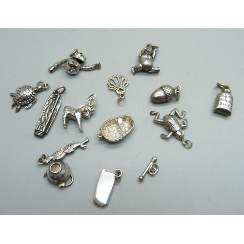 1035 - Fourteen silver charms, all test as silver, 33g