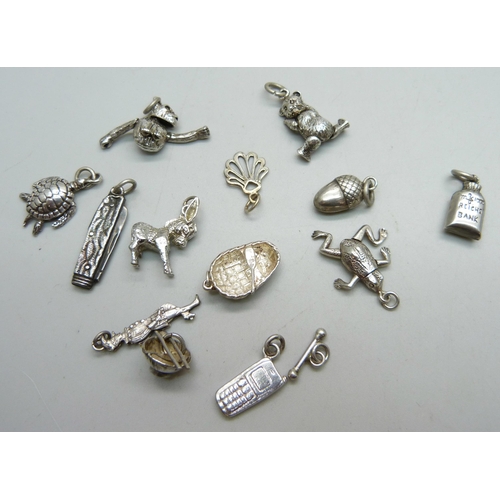 1035 - Fourteen silver charms, all test as silver, 33g