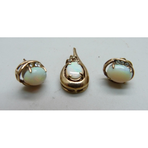 1036 - A yellow metal and opal pendant and a pair of matching earrings, 3g