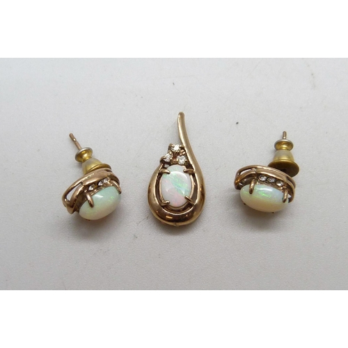 1036 - A yellow metal and opal pendant and a pair of matching earrings, 3g