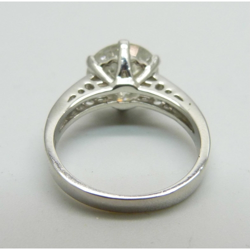 1056 - A hallmarked platinum solitaire diamond ring with diamond set shoulders, 3.80cts, 6.1g, M