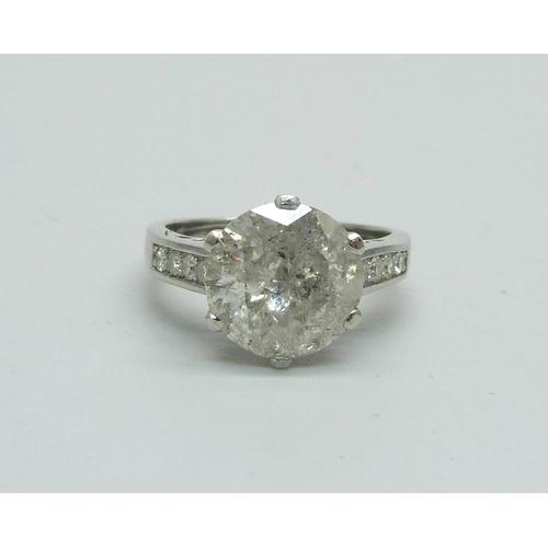 1056 - A hallmarked platinum solitaire diamond ring with diamond set shoulders, 3.80cts, 6.1g, M