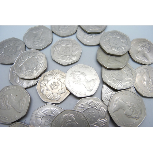 1064 - Twenty-four 50p pieces, 1973